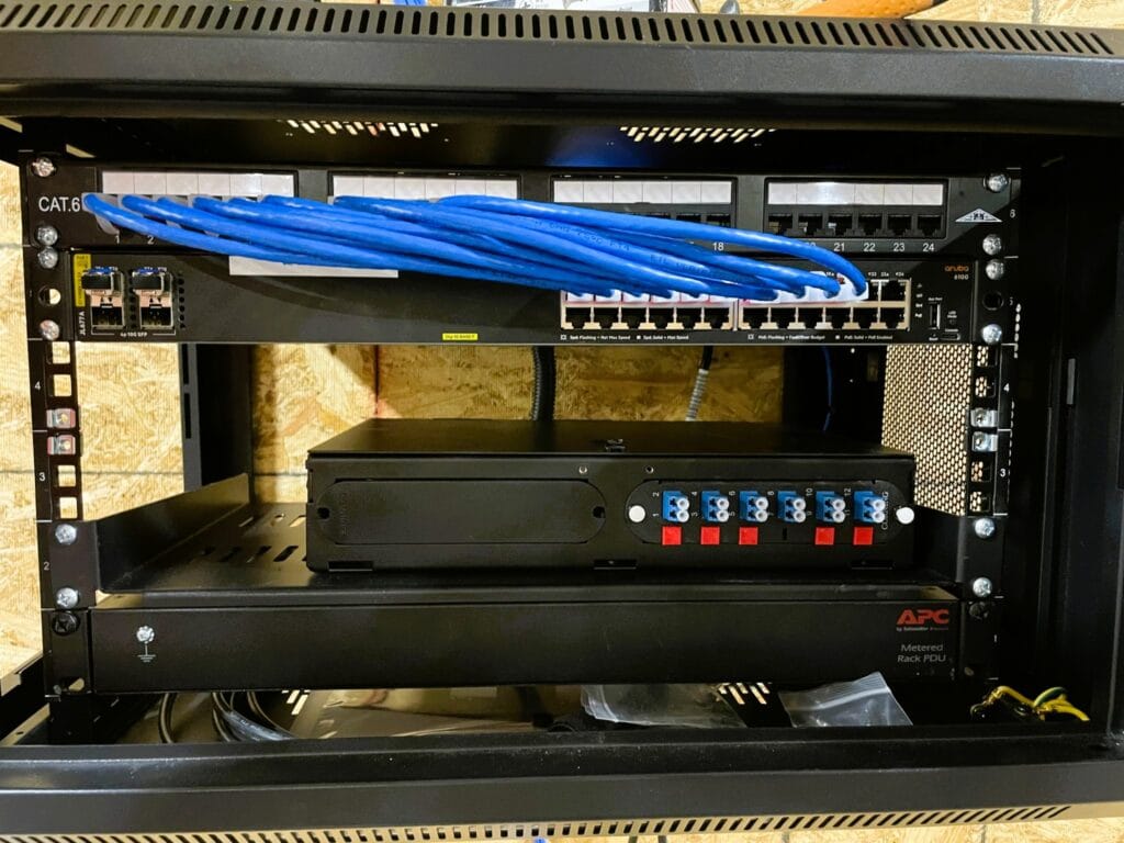 Rack containing a CAT6 patch panel, network switch, fiber cassette and APC power distribution unit