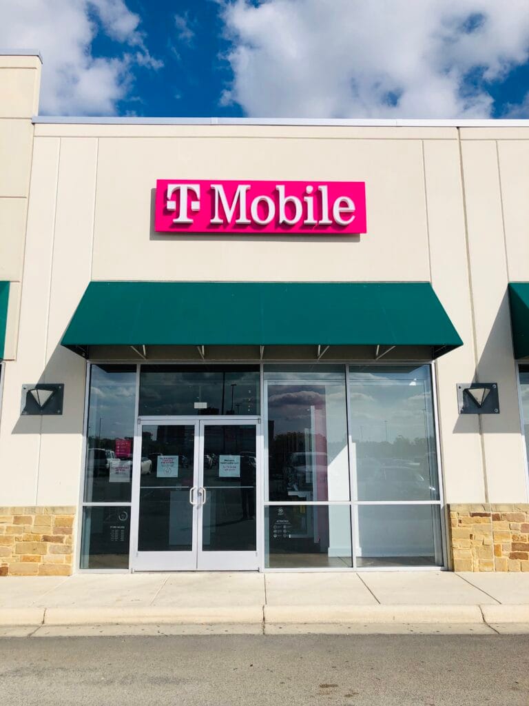 T-Mobile retail store exterior with pink signage and a teal awning